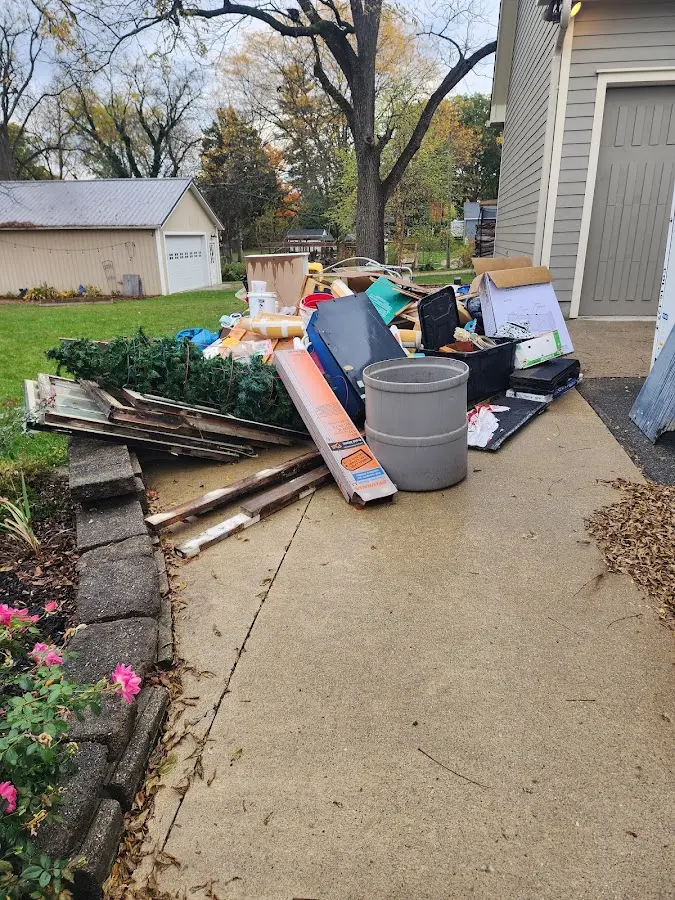 Dumpster being loaded with debris for Estate Cleanout Dumpster Rental in Wilton